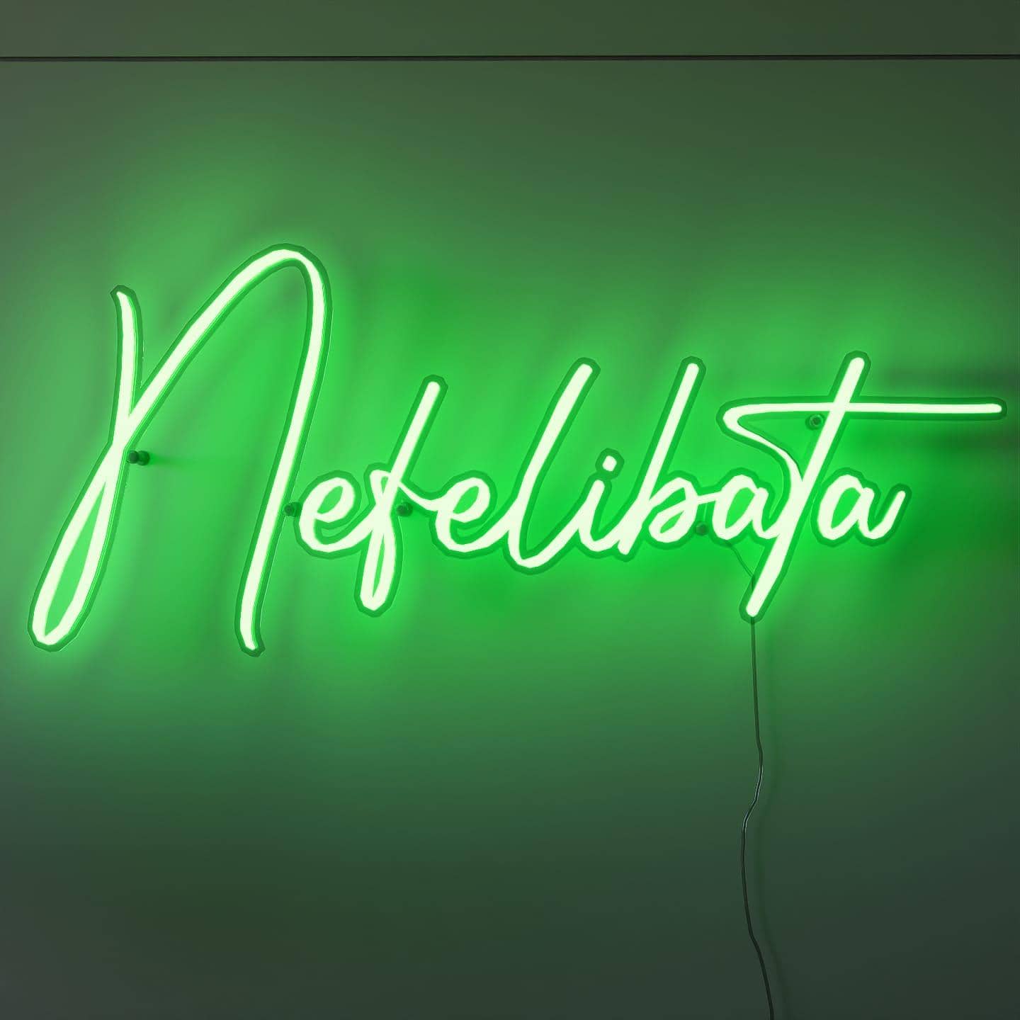 shot-of-lit-green-neon-lights-hanging-on-the-wall
