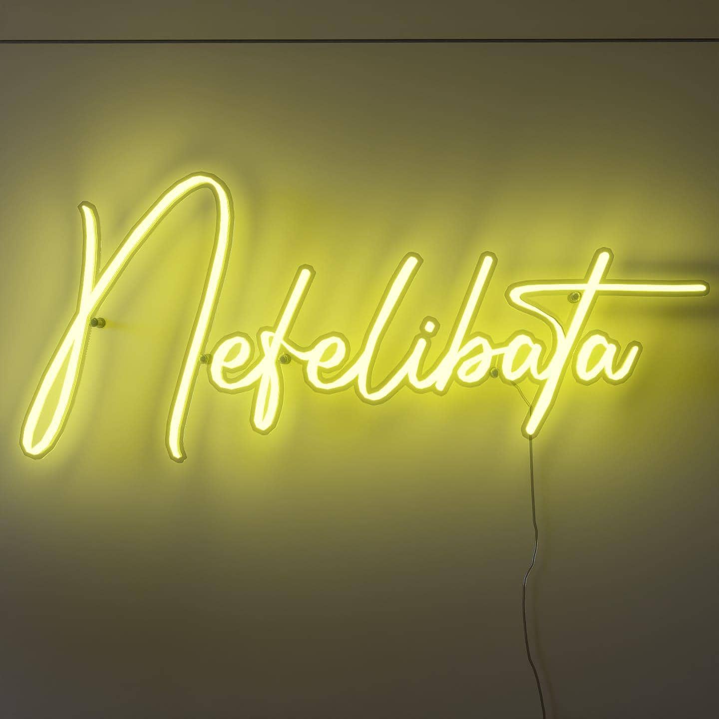 shot-of-lit-yellow-neon-lights-hanging-on-the-wall