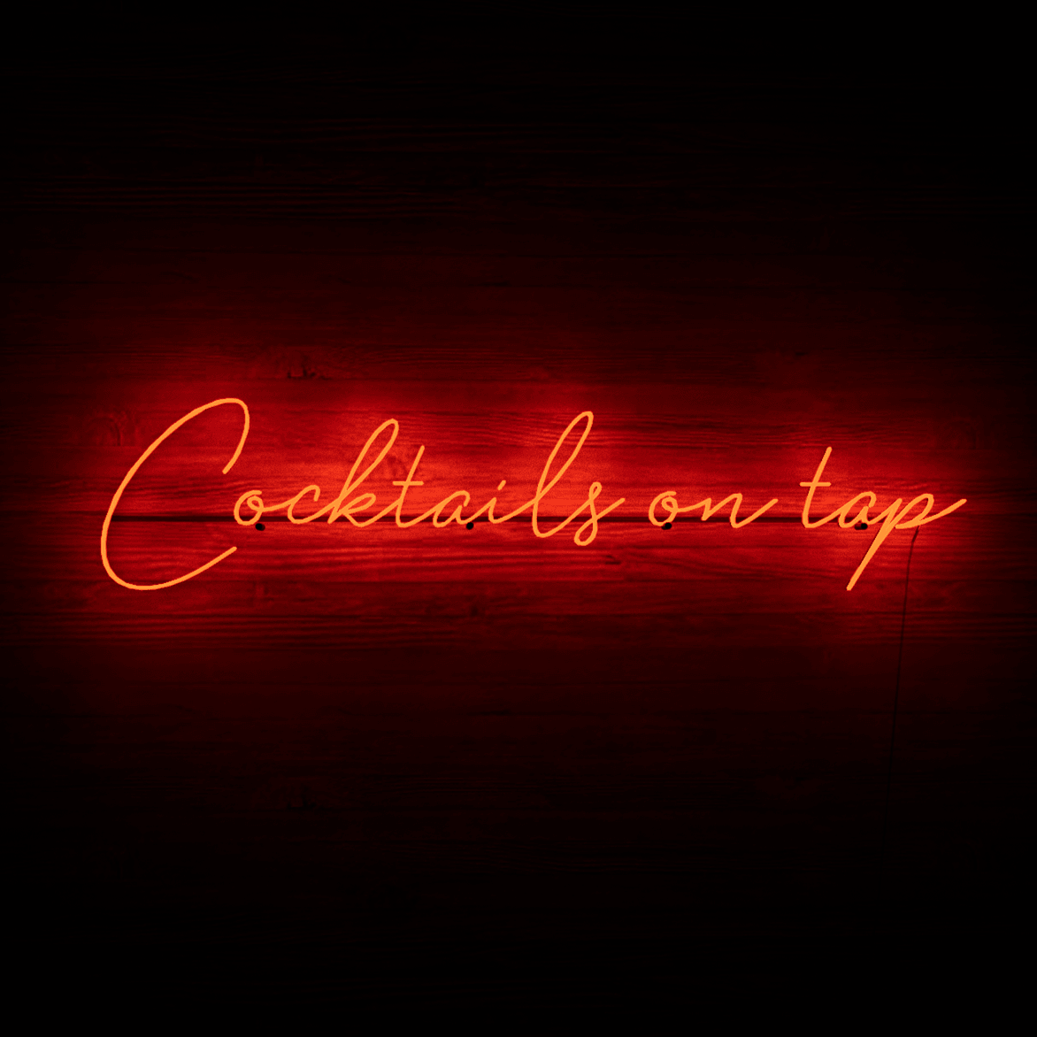 frontal-shot-of-lit-red-neon-lights-hanging-on-the-wall-at-night-cocktails-on-tap