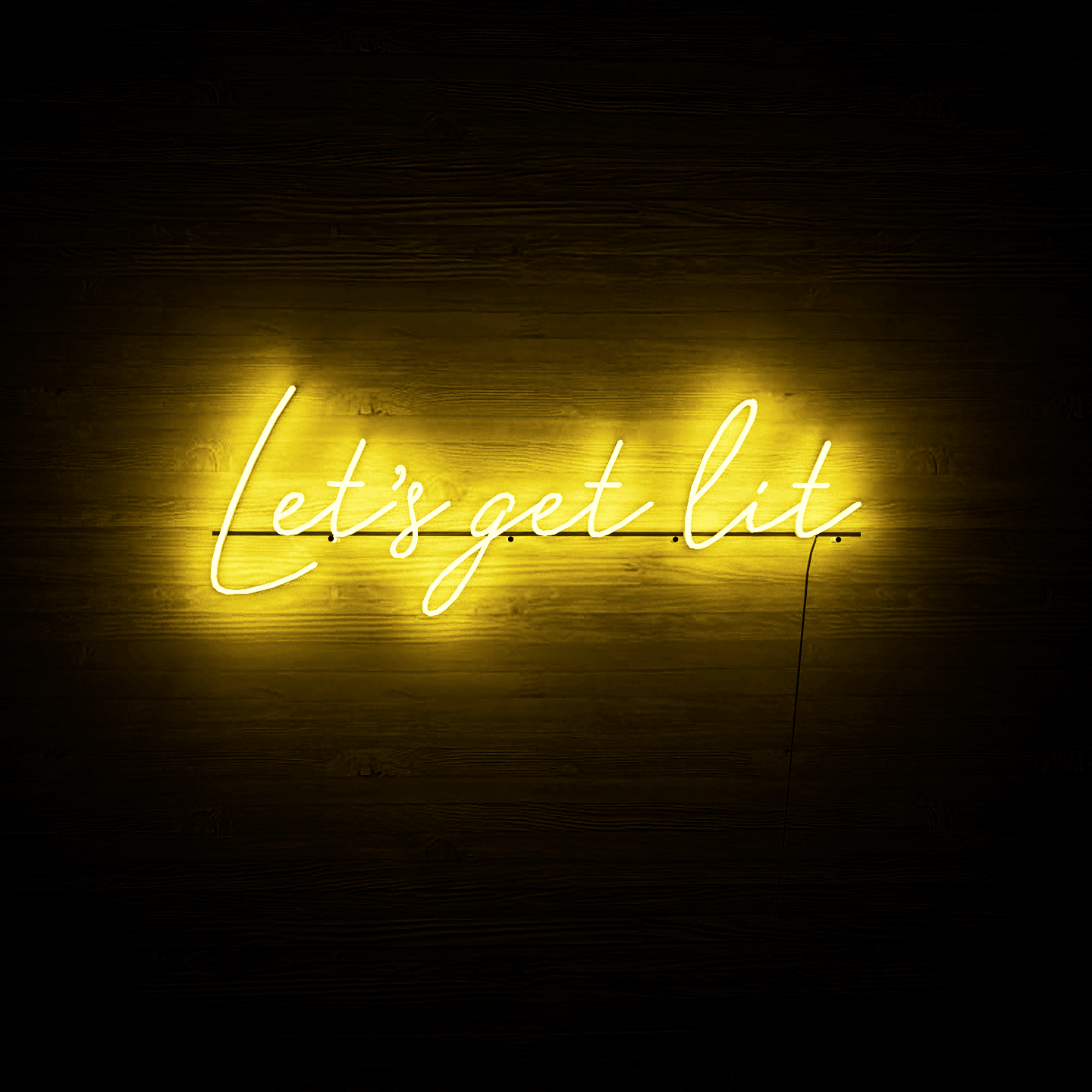 yellow-neon-lights-lit-up-at-night-and-hung-on-the-wall-for-display-let's-get-lit