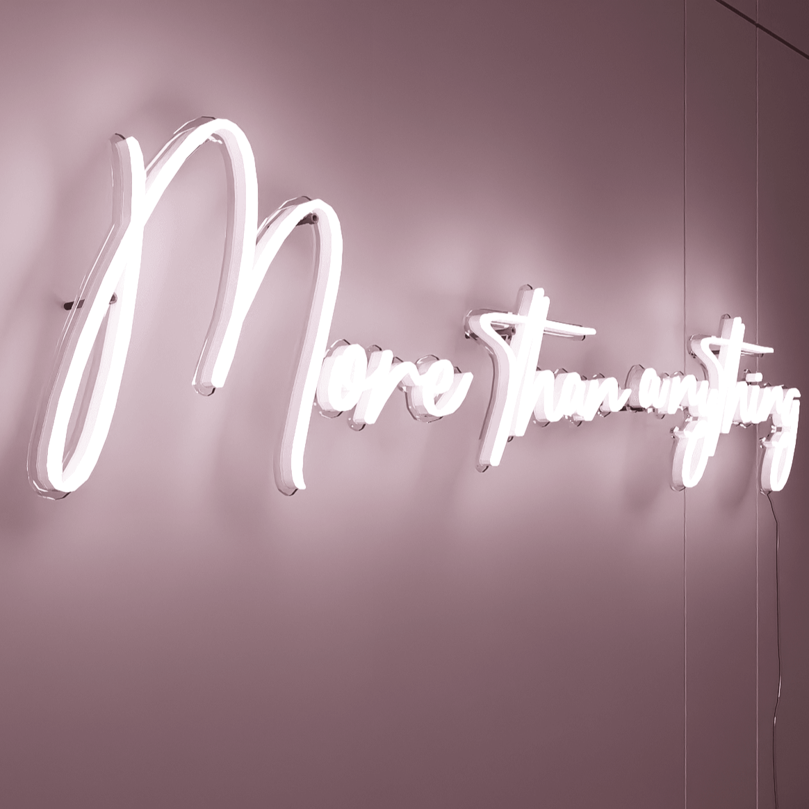 side-shot-of-illuminated-white-neon-lights-hanging-on-the-wall-at-nightmore-than-anything