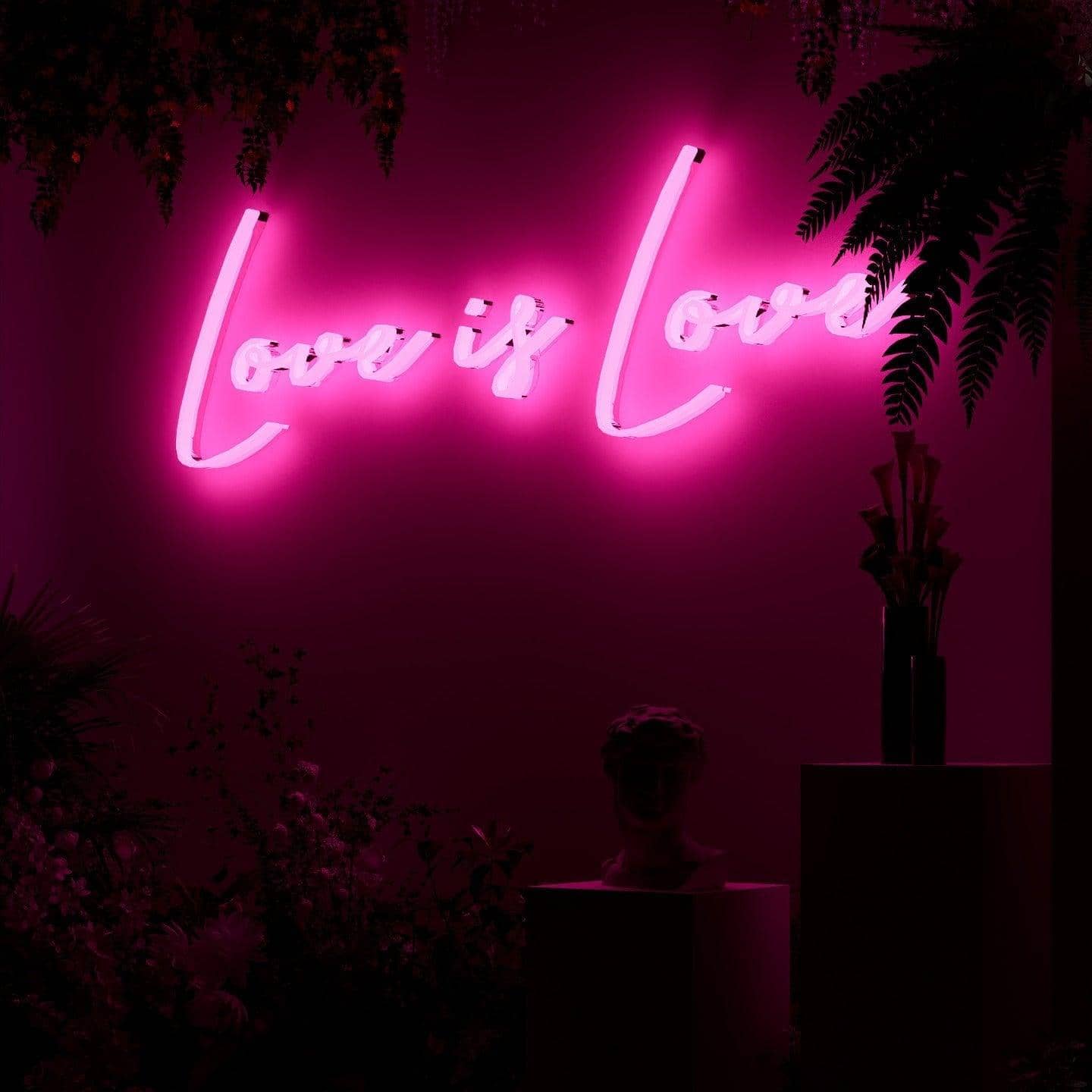 shot-of-lit-pink-neon-lights-hanging-on-wall-for-display-love-is-love