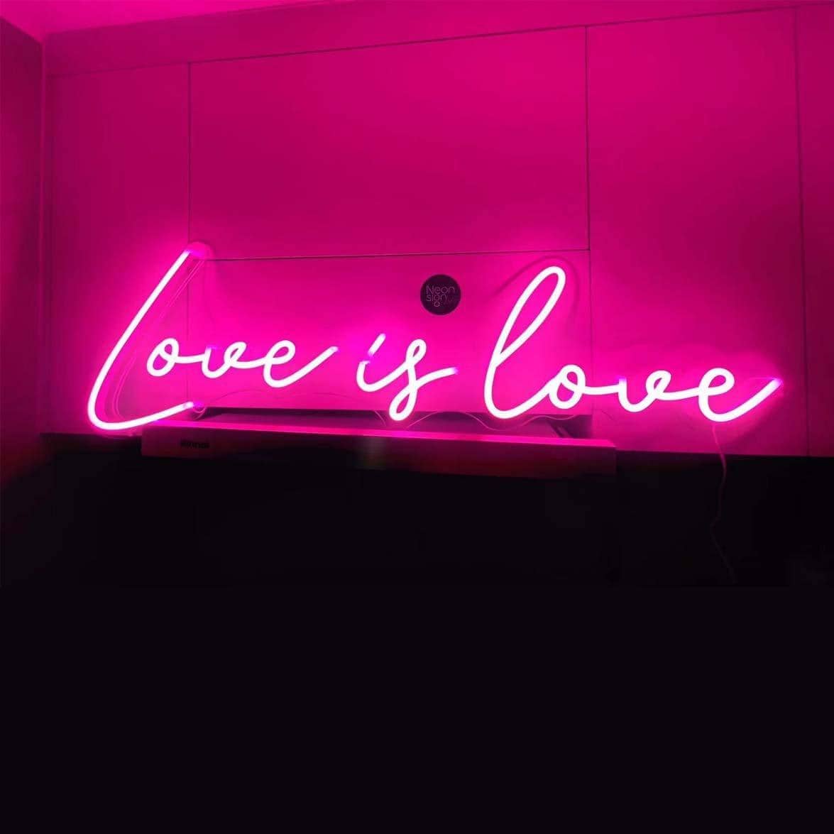 dark-night-shot-with-pink-neon-lights-hanging-on-the-wall-for-display-love-is-love