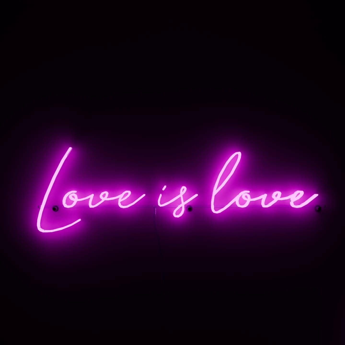 dark-night-shot-with-pink-neon-lights-hanging-on-the-wall-for-display-love-is-love