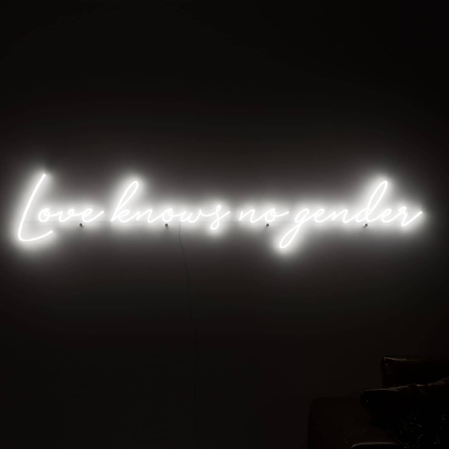 dark-night-shot-with-lit-white-neon-lights-hanging-on-the-wall-for-display-love-knows-no-gender