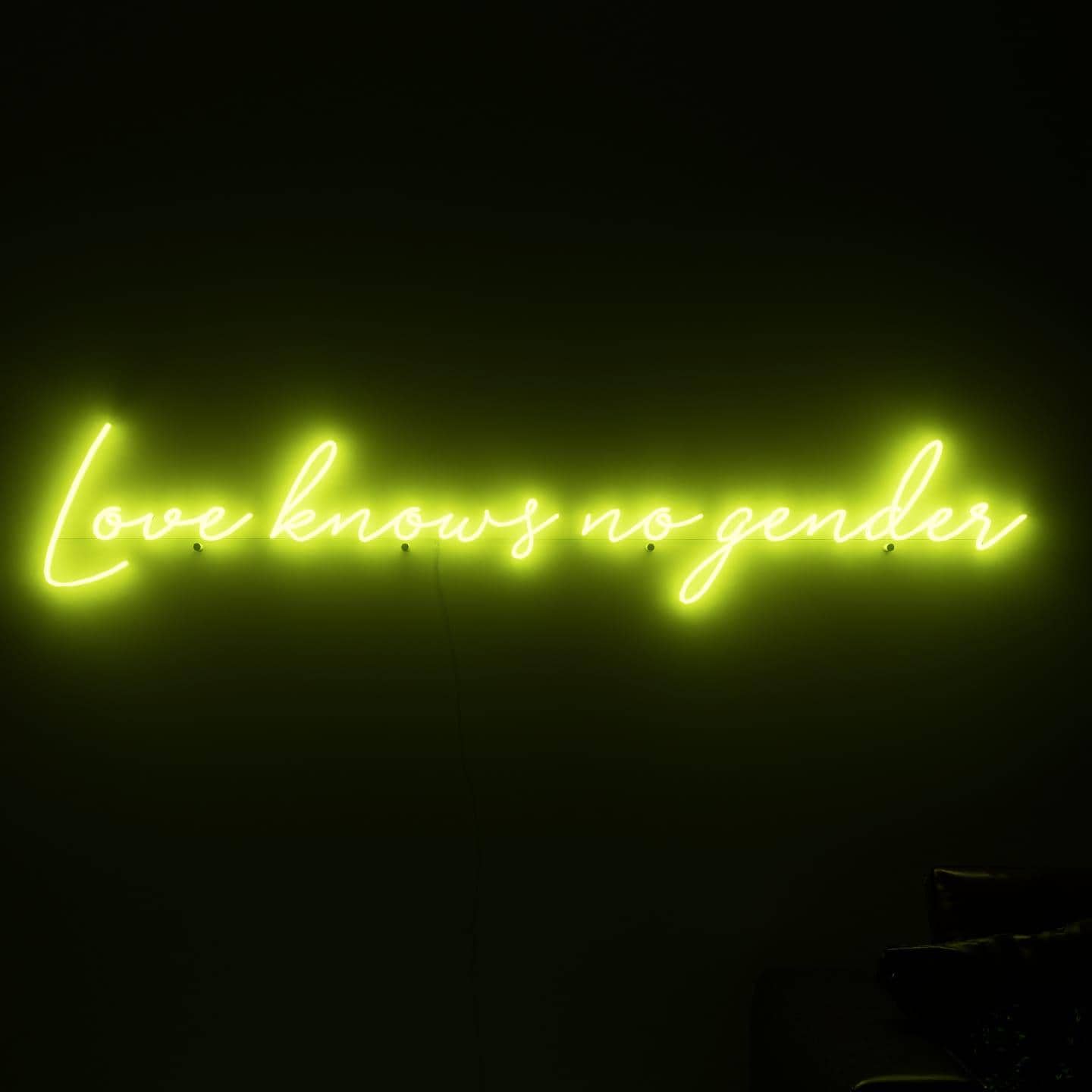 dark-night-shot-with-golden-neon-lights-hanging-on-the-wall-for-display-love-knows-no-gender