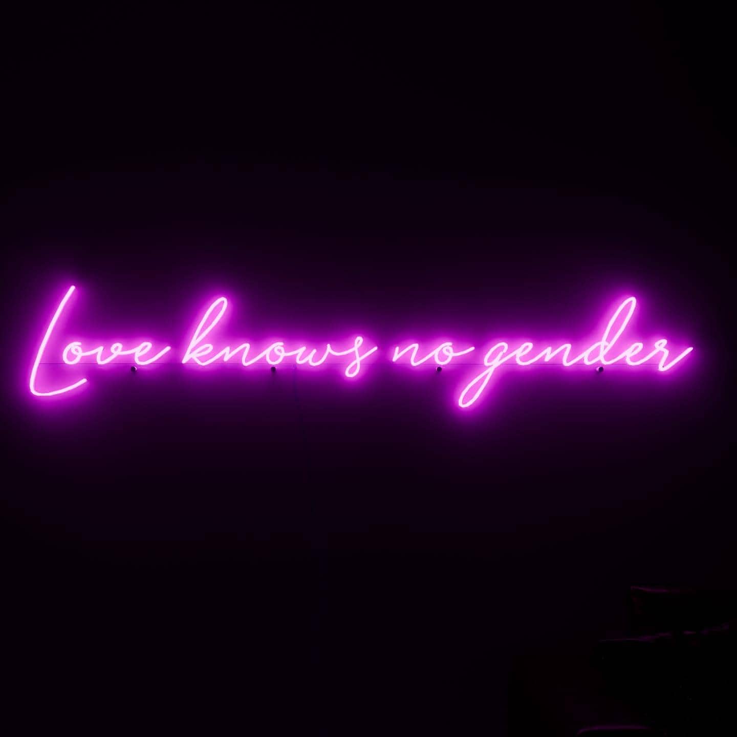 dark-night-shot-with-pink-neon-lights-hanging-on-the-wall-for-display-love-knows-no-gender
