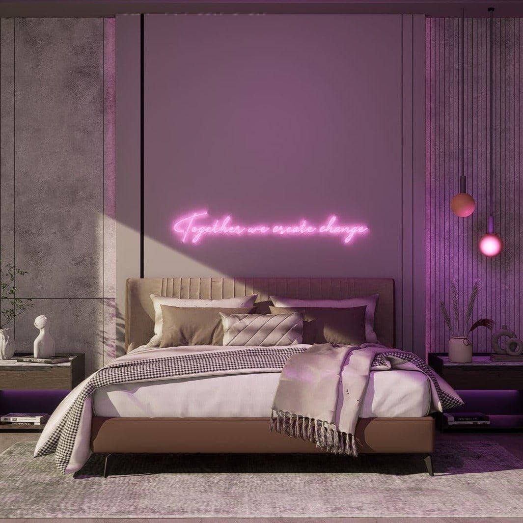 frontal-shot-of-lit-pink-neon-lights-hanging-in-bedroom-during-daytime-together-we-create-change