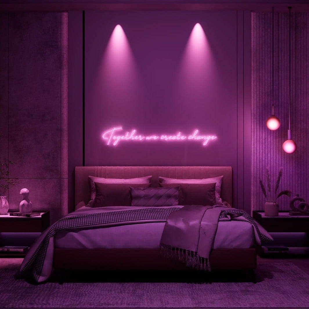 frontal-shot-of-lit-pink-neon-lights-hanging-in-bedroom-at-night-together-we-create-change